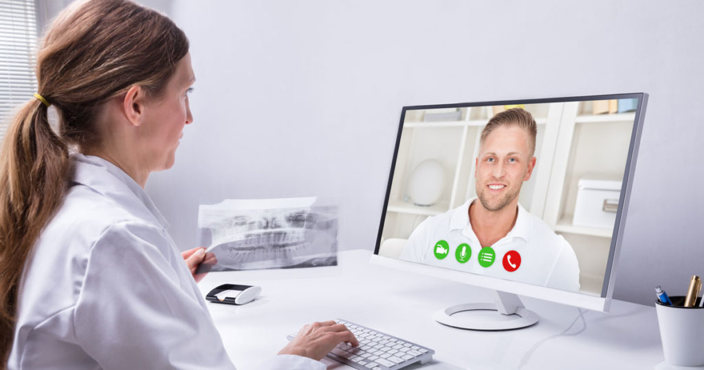 Dentist and Patient Having Virtual Smile Consultation Dentist and Patient Having Virtual Smile Consultation